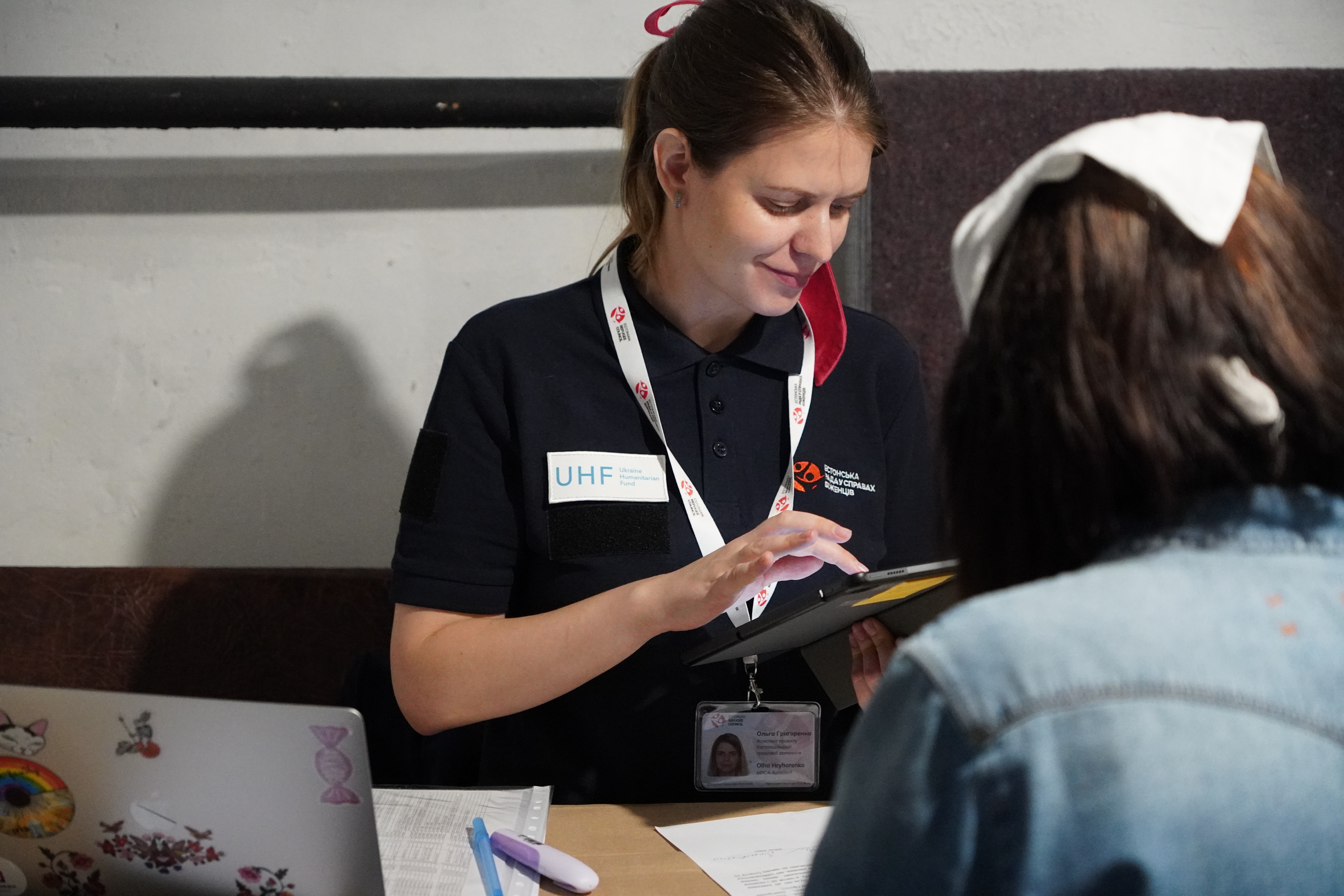 ERC field trip in Ukraine woman checking a beneficiary