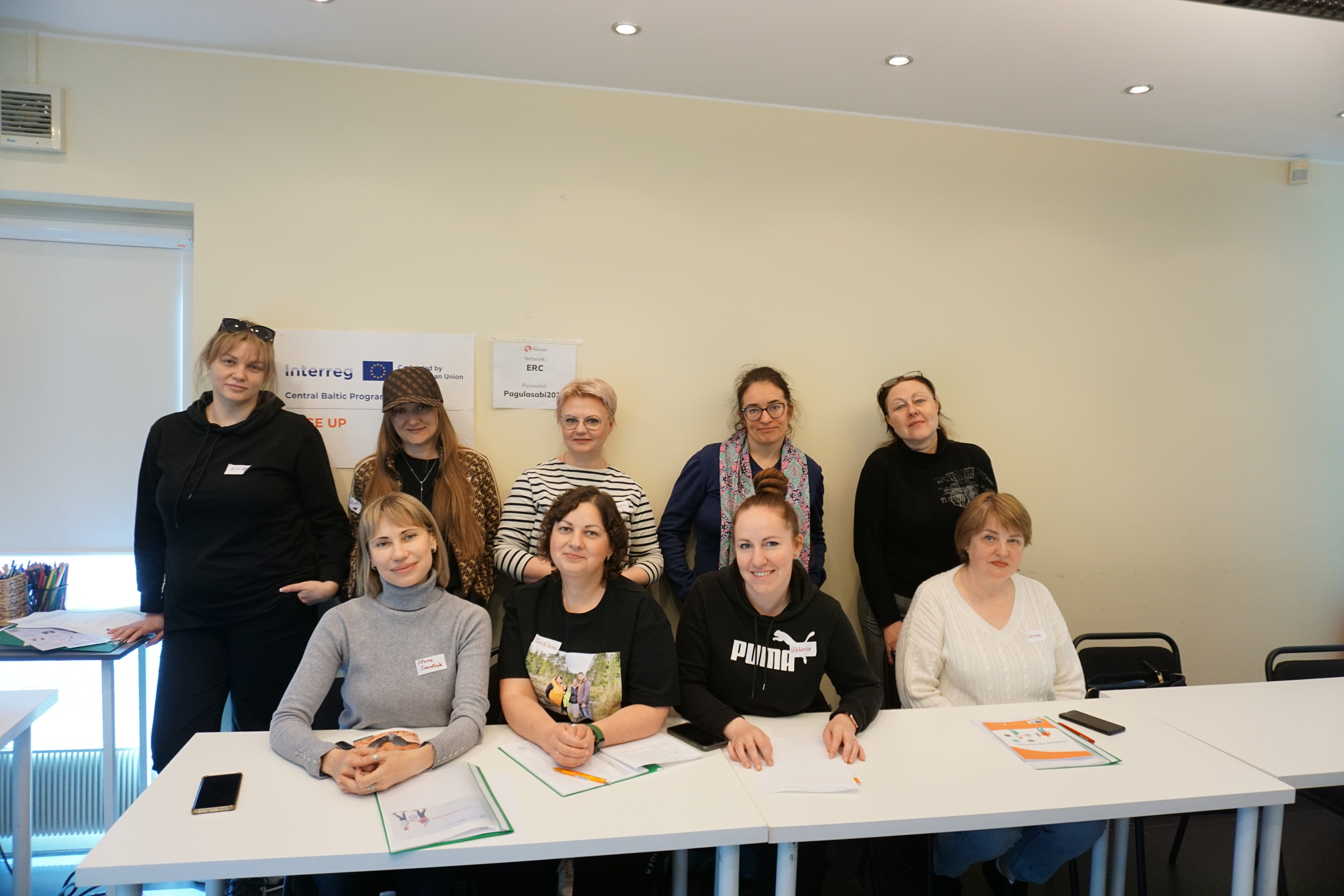 People posing behind a table 