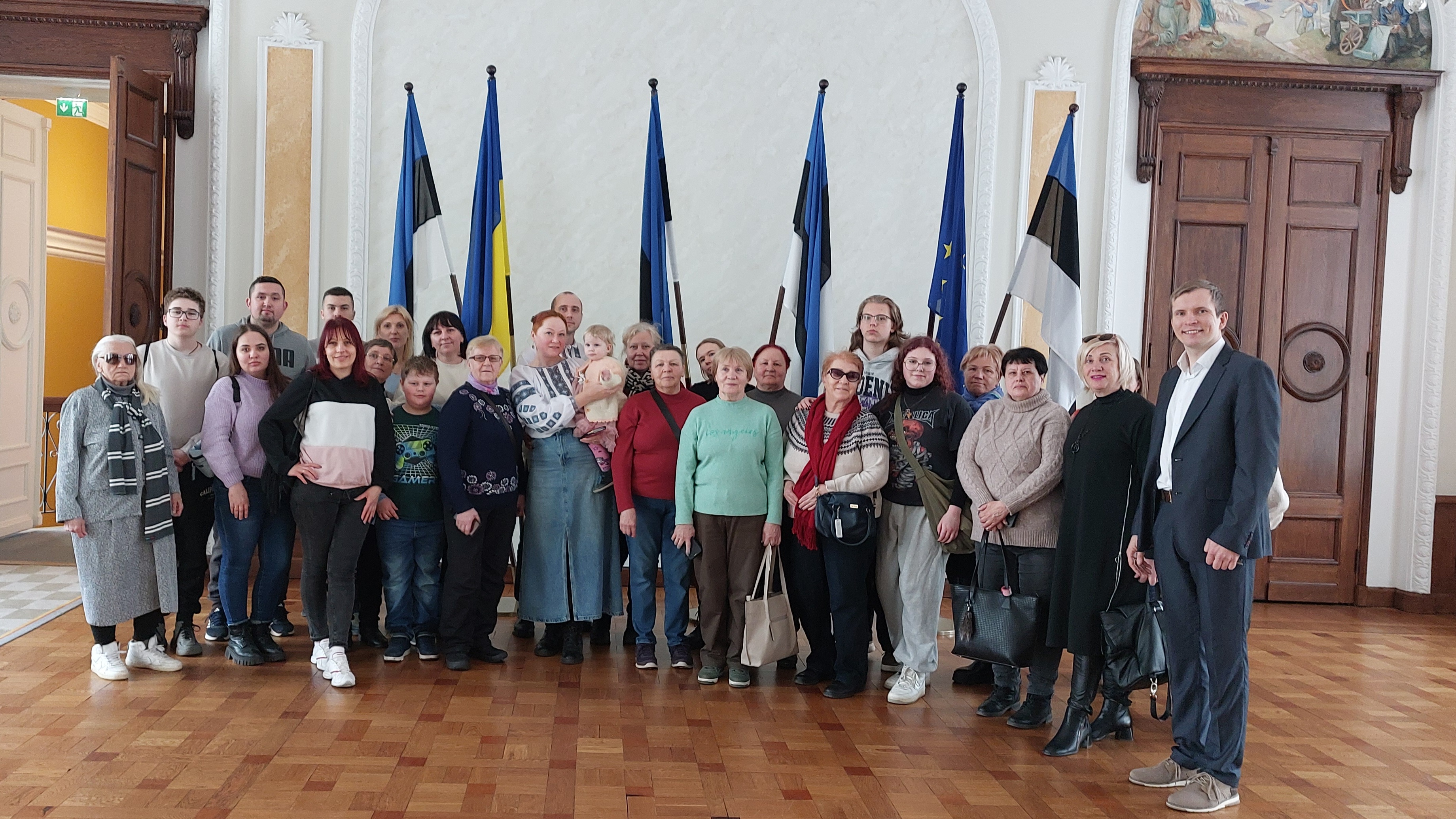 People standing infront of flags
