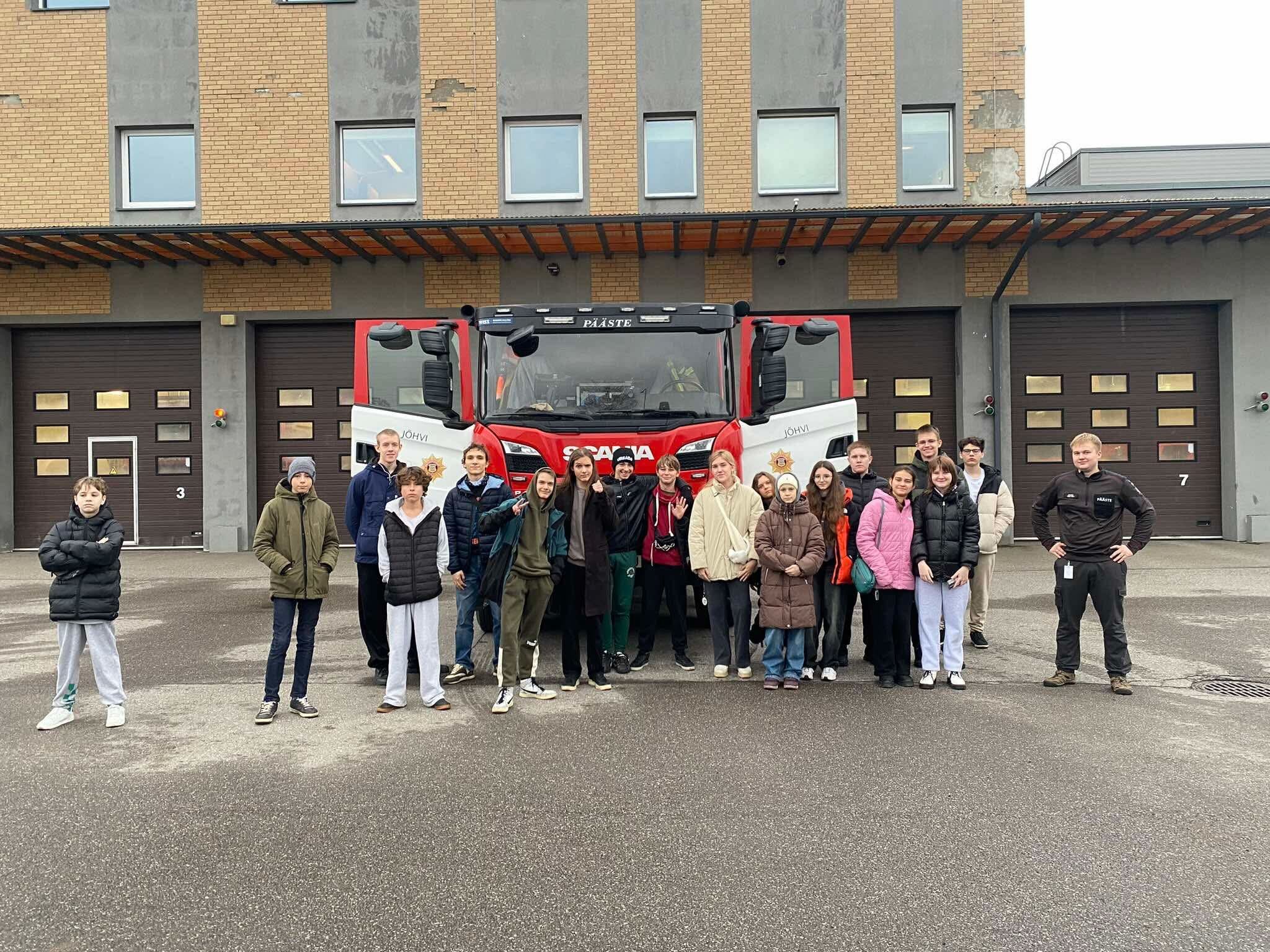 refugee youth infront of a firetruck 