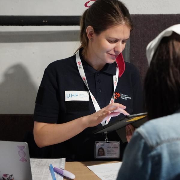 ERC field trip in Ukraine woman checking a beneficiary