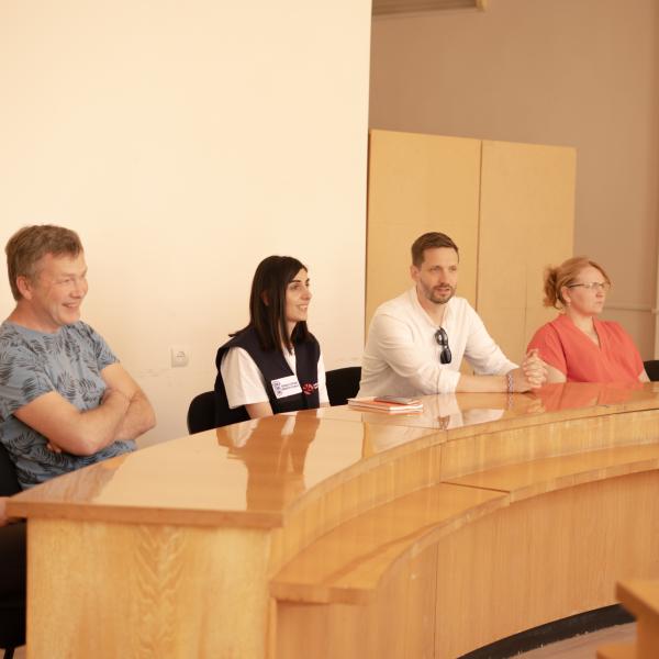 People sitting at a table discussing 