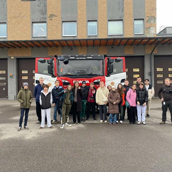 refugee youth infront of a firetruck 